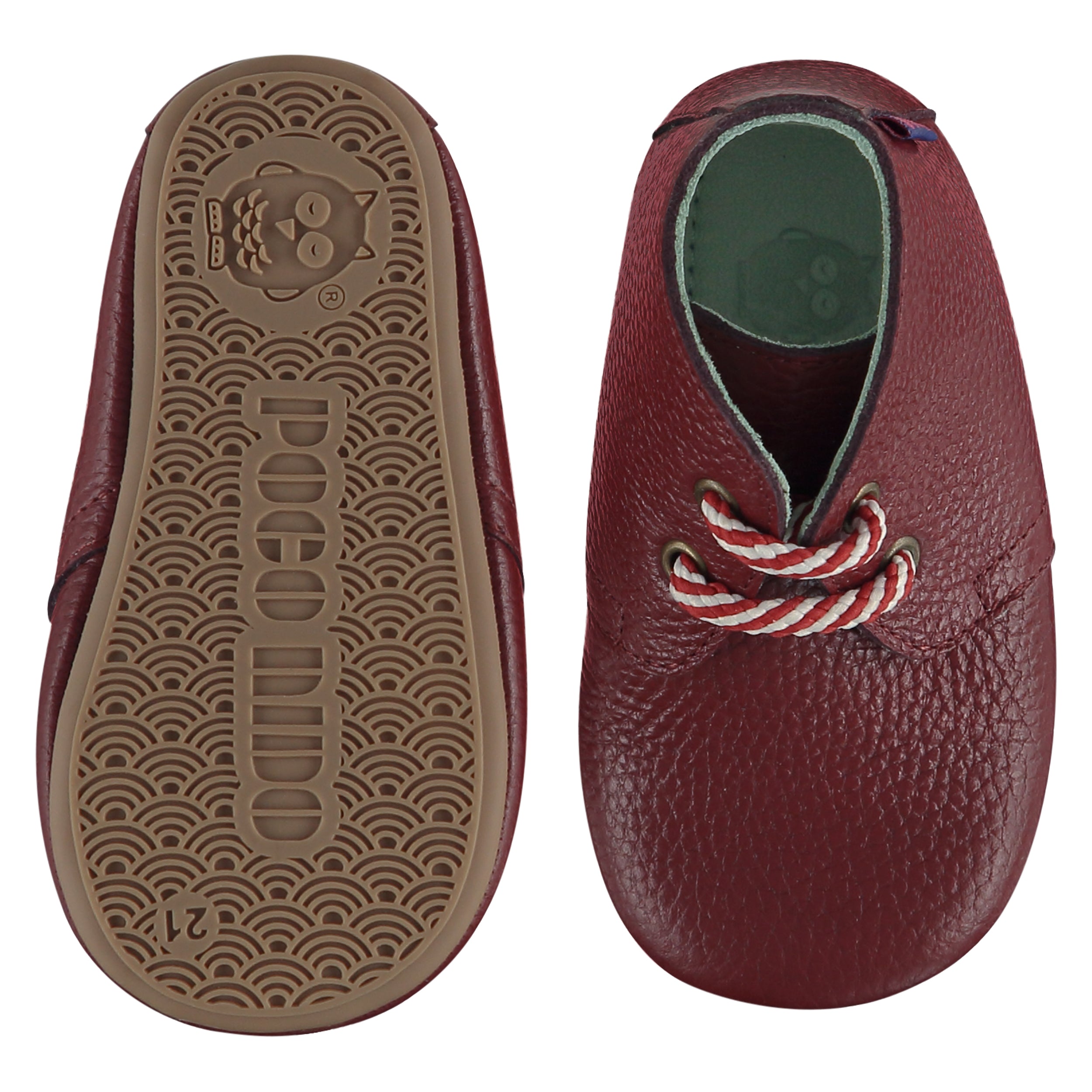 A pair of childrens lace up desert boots, one viewed from the top, one is a view of the sole. They are in red wine colour leather with striped laces. They have a pale blue leather lining and insole. The sole is a natural gum colour.