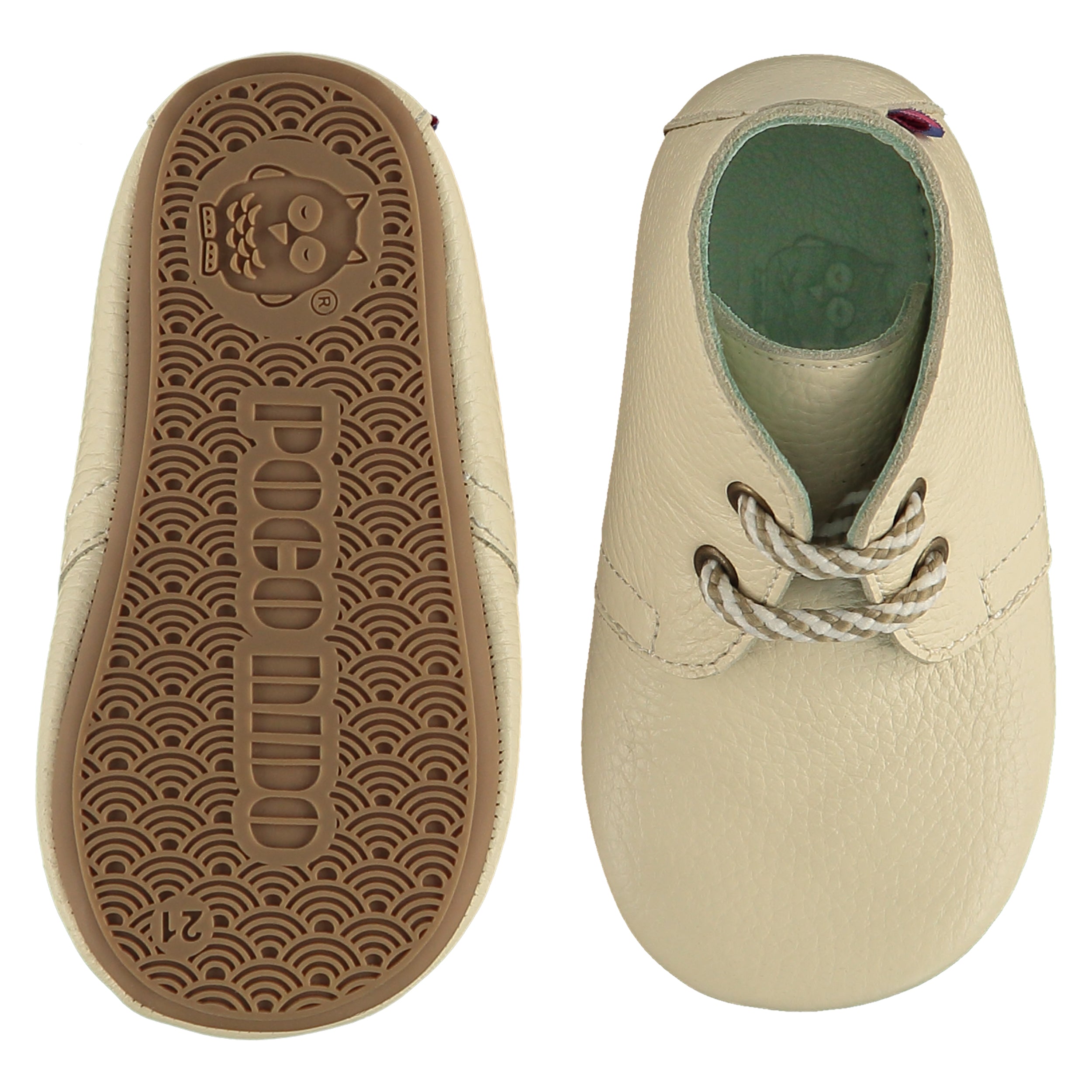 A pair of childrens lace up desert boots, one viewed from the top, one is a view of the sole. They are in chalk colour leather with striped laces. They have a pale blue leather lining and insole. The sole is a natural gum colour.