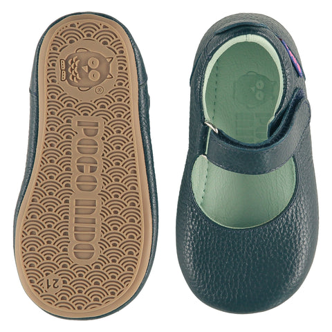 A pair of childrens Mary Jane shoes, one viewed from the top, one is a view of the sole. They are in chalk colour leather with a pale blue leather lining and insole. They have an adjustable strap. The sole is a natural gum colour.