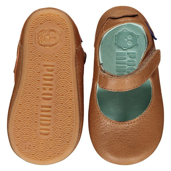 Mighty Shoes Tan Mary Jane. Children's shoe in tan colour leather. Barefoot shoe with self fastening strap and a flat, super flexible TPU rubber sole. The sole has the Poco Nido logo on it. View of top and sole. Poco Nido baby, toddler and childrens shoes make unique gifts - as christmas gifts, stocking fillers, baby shower gifts, new parent gifts, to celebrate new walking skills and many other occasions. They are great toddler shoes too and are perfect for daycare settings.