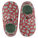 A pair of childrens adjustable strap shoes, viewed from the top. They are facing in opposite directions. They are in red leather with an all over print of hedgehogs. They have a  pale blue leather lining and insole. The sole is a natural gum colour.