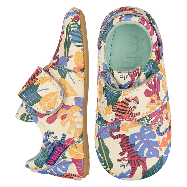 Mighty Shoes Rainbow Tiger Strap Shoe. Children's shoe in cream leather with colourful jungle tiger print. Barefoot shoe with a self fastening strap and a flexible TPU rubber sole. The sole has the Poco Nido logo on it. View of top and side. Poco Nido baby, toddler and childrens shoes make unique gifts - as christmas gifts, stocking fillers, baby shower gifts, new parent gifts, to celebrate new walking skills and many other occasions. They are great toddler shoes too and are perfect for daycare settings.